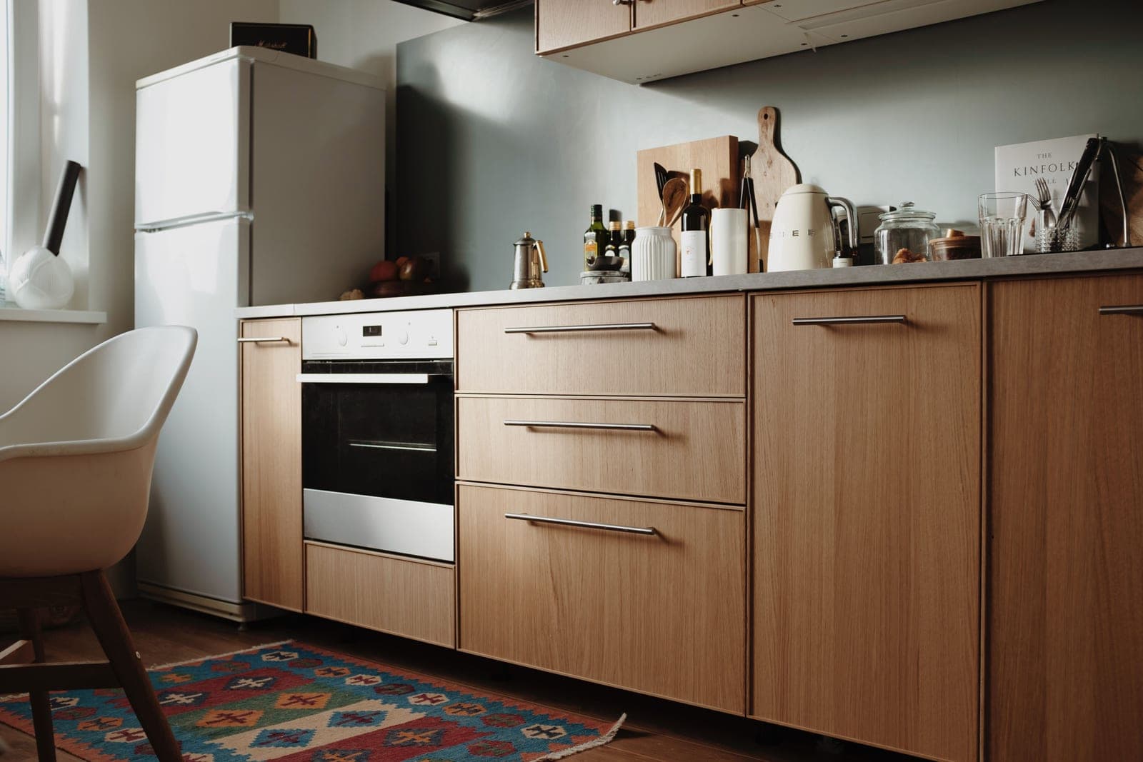 A warm, bright kitchen counter with wood and clean surfaces